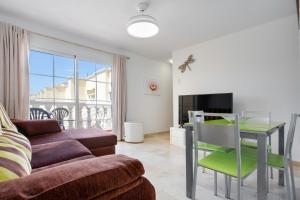 a living room with a couch and a table at Marysol in Caleta De Fuste