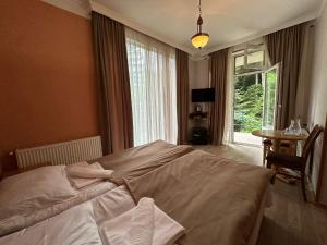 Postel nebo postele na pokoji v ubytování Nunisi Forest Hotel & SPA