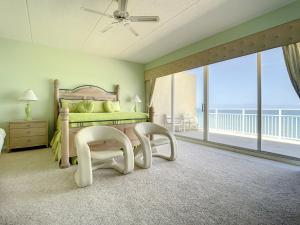a bedroom with a bed and a balcony at Penthouse Condo with wrap around views of the ocean - SR802 in Edgewater +43 photos