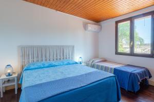 Posteľ alebo postele v izbe v ubytovaní Villa piscina a due passi dal mare