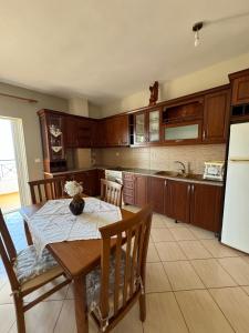 una cucina con tavolo, sedie e frigorifero di Guesthouse Kleanth a Sarandë Altre 18 foto