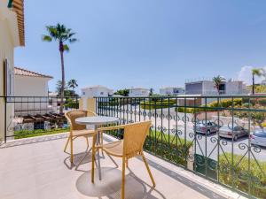 a patio with a table and chairs on a balcony at AL Casa Raha in Quinta do Lago