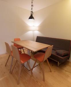 a dining room table with four chairs and a lamp at GuestReady - Catorze de Outubro Houses - 387 in Vila Nova de Gaia