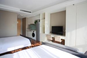 Postel nebo postele na pokoji v ubytování Yashi International Aparthotel