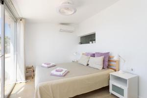 a white bedroom with a bed with two towels on it at Casita Seafront Oasis del Sur in San Miguel de Abona +24 photos