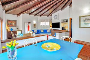 a dining room and living room with a blue table at Country House Sardinia in Olbia