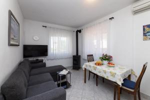 a living room with a couch and a table at Apartman Angelina in Supetar