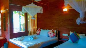 Letto o letti in una camera di Sigiri Sky Home & TreeHouse