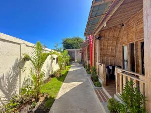a sidewalk between two buildings next to a building at Nature Stay Uluwatu in Uluwatu