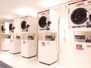 a row of washing machines on display in a store at Hotel Elcient Osaka Umeda in Osaka