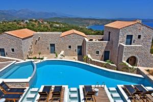 a villa with a swimming pool and a view at Opuntia Boutique Hotel in Kalívia