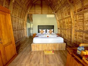 a bedroom with a bed in a bamboo room at Nature Stay Uluwatu in Uluwatu