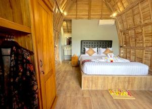 a bedroom with a large bed in a room at Nature Stay Uluwatu in Uluwatu
