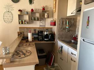 a small kitchen with a sink and a refrigerator at Appartement charmant à Bandol 30 m² avec vue sur la mer. in Bandol