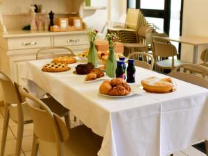 a white table with pastries and bottles on it at Le Navi in Ortona