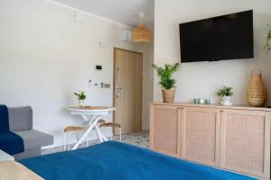 a living room with a tv on a wall at Apartament Dla Ciebie III in Ustronie Morskie