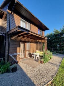 a house with a patio in front of it at Vila DRAGONFLY in Šventoji