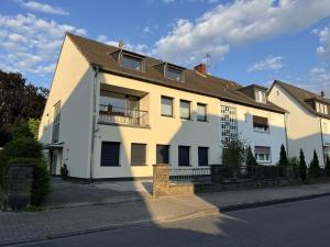 a white building with a balcony on a street at Cozy Apartment in Leverkusen in Leverkusen