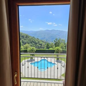 a view of a swimming pool from a window at Hotel Palace Savuto in Malito