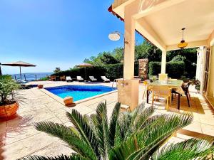 a patio with a pool and a table and chairs at Villa Venus Privacy & Relax in Mošćenička Draga