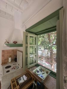 a small kitchen with a window and a stove at Patmos Villas in Grikos