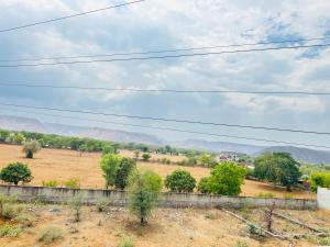 a view of a field with mountains in the background at Bhanu bhawan in Jaipur
