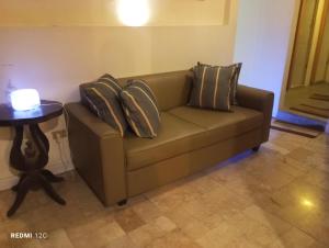 a couch with pillows on it in a living room at Airport Hostel Manila in Manila +27 photos