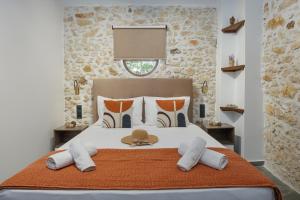 a bedroom with a large bed with a hat on it at Anassa Luxury Apartment 13 in Heraklio Town