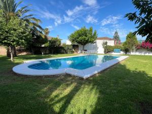 a swimming pool in the yard of a house at Carmen Home in Córdoba