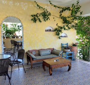 a living room with a couch and a table at Harmony resort in Parga