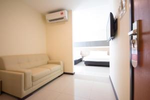 a living room with a couch and a bed at 118 Hotel Macalister in George Town