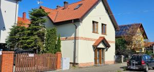 a white house with a red roof at Keja in Łeba