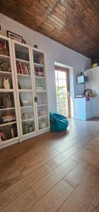 a room with white cabinets and a wooden floor at Keja in Łeba