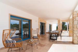 a living room with chairs and a table at Tenuta di Uma by Perle di Puglia in Carovigno