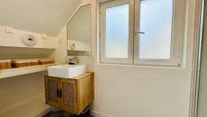 a bathroom with a sink and a window at Villa à la plage - au coeur de Stella-Plage in Stella-Plage +14 photos