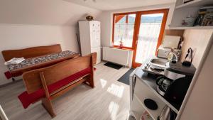 a small room with a kitchen with a refrigerator at Casa Ferenczi Vendégház in Sovata +17 photos