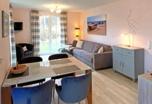a living room with a couch and a table at Haus Meeresblick Ferienwohnung Kra in Baabe