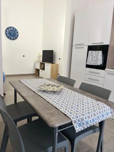 a dining room with a table and some chairs at Azzurra in Terrasini