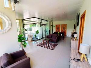a living room with purple couches and a living room with at ONYX B&B Bed and Breakfast in Euscara