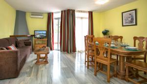 a living room with a table and a dining room at Ona Campanario in La Cala de Mijas