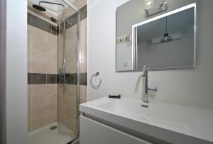 a bathroom with a sink and a shower at Chambre Verte in Auzat +14 photos