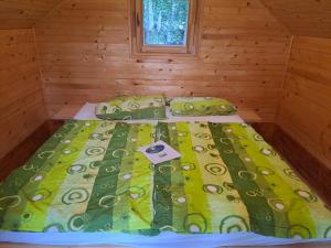 a bed in a wooden room with a bed sidx sidx sidx at Forest Lodge in Rečica ob Savinji