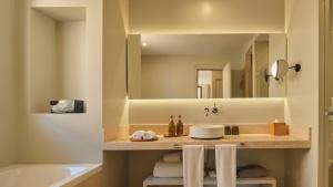 a bathroom with a sink and a tub and a mirror at Sant Jaume Design Hotel in Palma de Mallorca