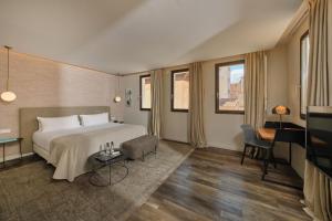 a hotel room with a bed and a television at Sant Jaume Design Hotel in Palma de Mallorca
