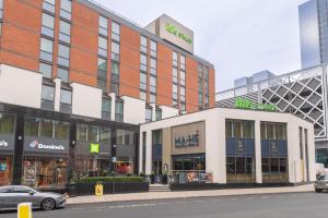 a shopping centre with a car parked in front of it at ibis Styles Leeds City Centre Arena in Leeds