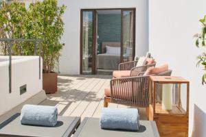 a patio with chairs and a table and a couch at Sant Jaume Design Hotel in Palma de Mallorca