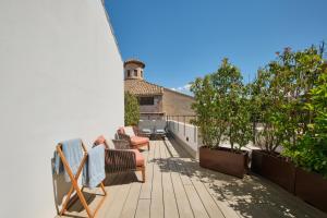 a balcony with chairs and trees on a house at Sant Jaume Design Hotel in Palma de Mallorca