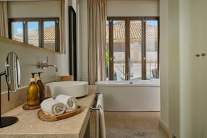 a bathroom with a tub and a sink and a bath tub at Sant Jaume Design Hotel in Palma de Mallorca