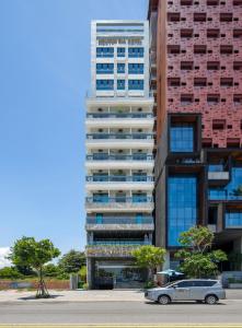a car parked in front of a tall building at Nguyen Gia Hotel in Danang +46 photos