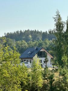 a house with solar panels on top of it at Mazurski Domek - Wake Up Home Ogonki in Ogonki